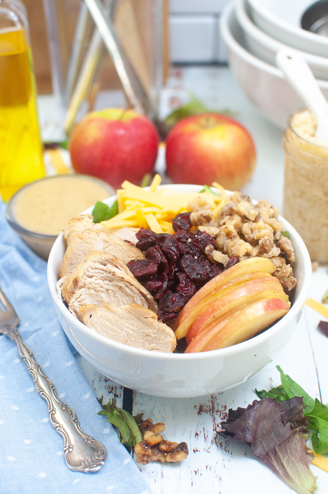 Salad topped with Chicken, cheese, walnuts, cranberries, and apples.