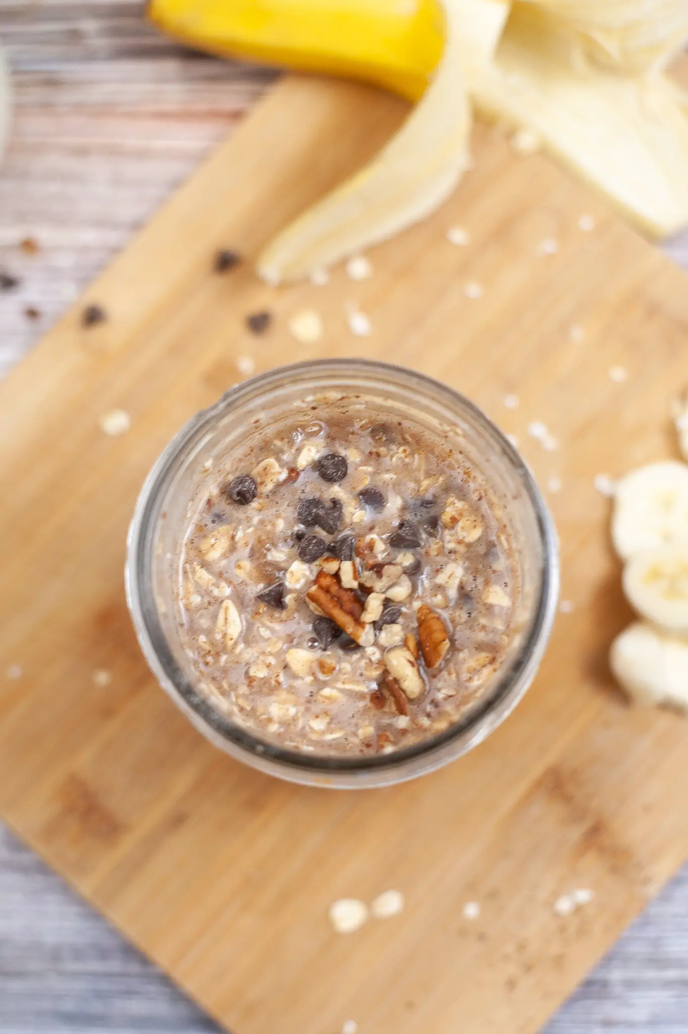 Ingredients for Chocolate Chip Banana Overnight Oats mixed in a jar. 