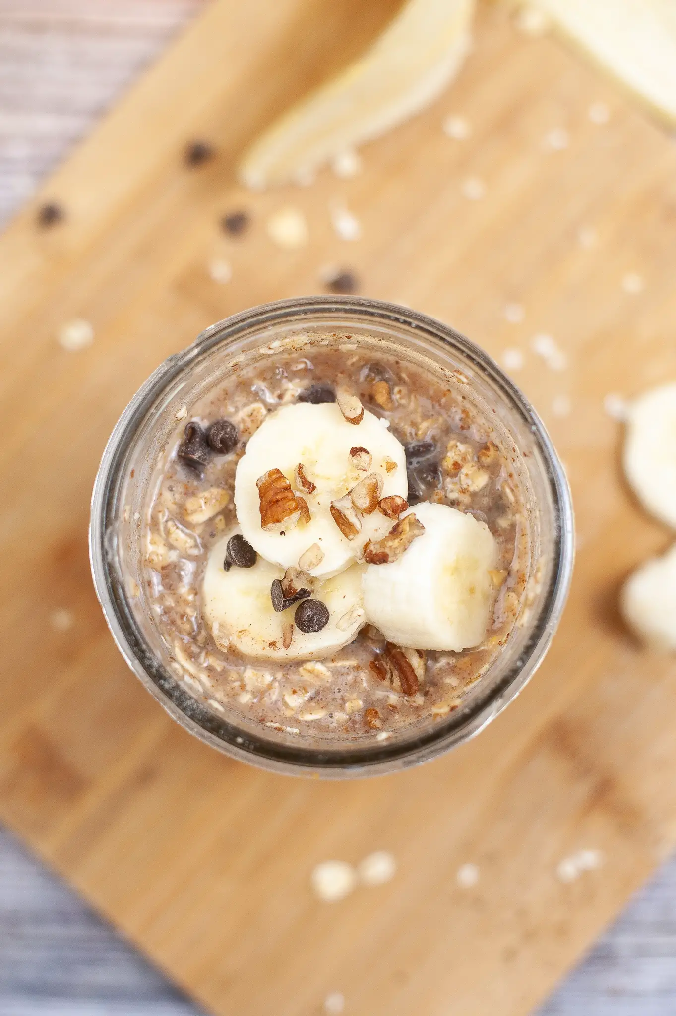 Chocolate Chip Banana Overnight Oats in a jar topped with banana slices. 