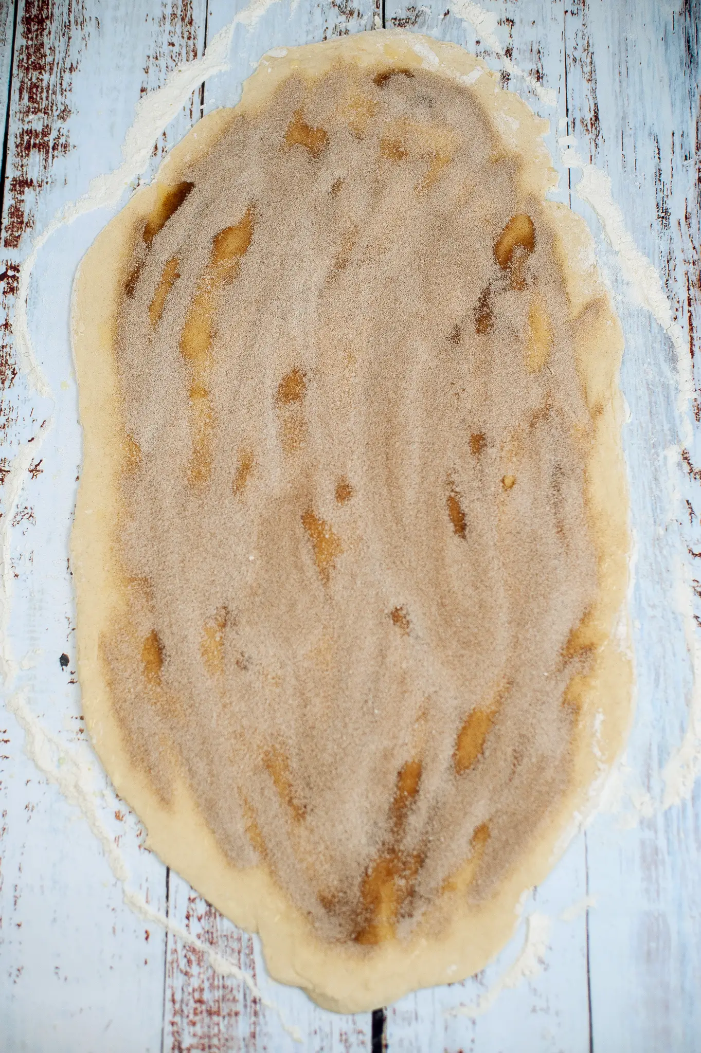 Butter, cinnamon and sugar filling added to cinnamon roll dough.