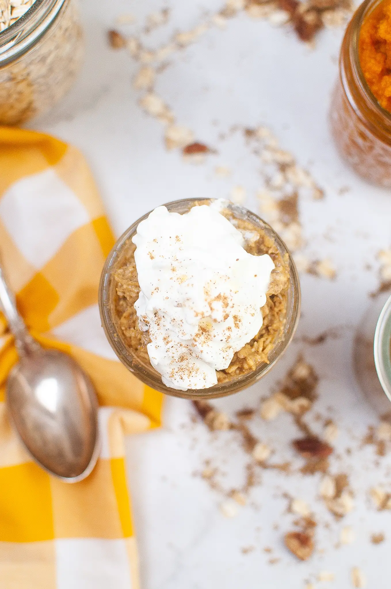 All of the ingredients in a jar, mixed up, topped with whipped cream.