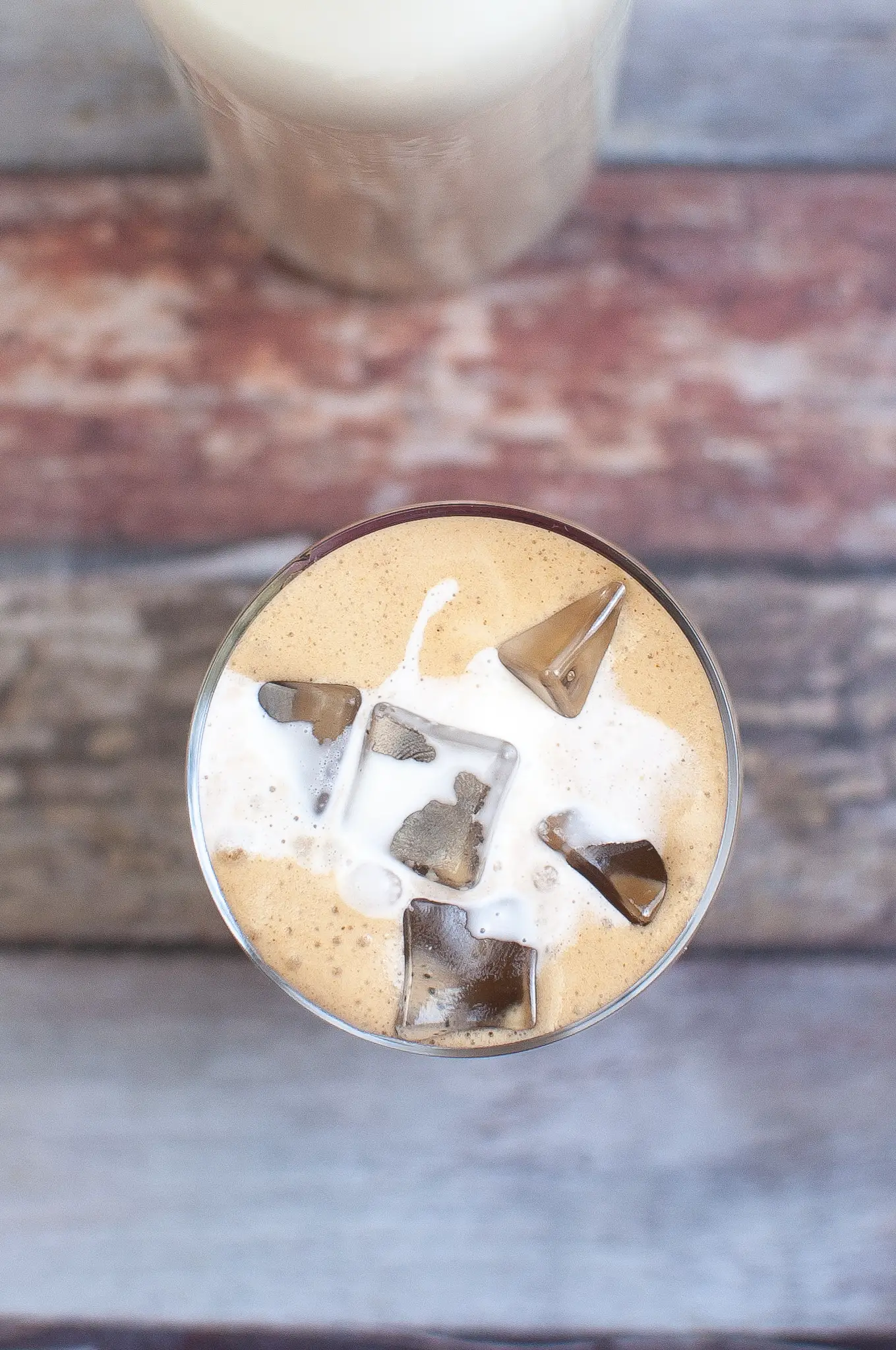 Iced Bulletproof coffee blended in a glass over ice.